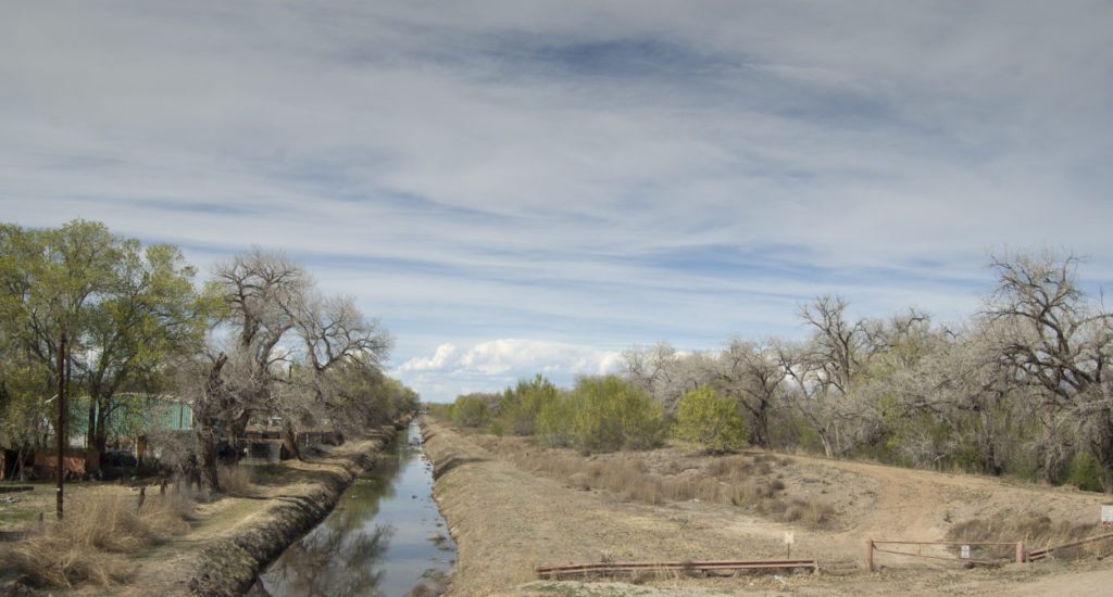 Early spring runoff courses through an acequia just north of the planned Santolina development.  Photo by Margaret Wright