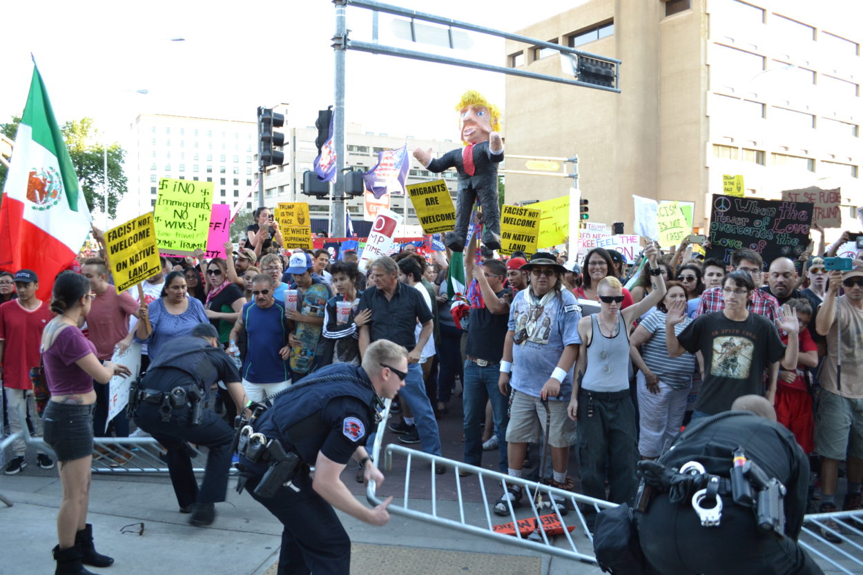 Photos: Trump rallies thousands, protesters outside cause chaos