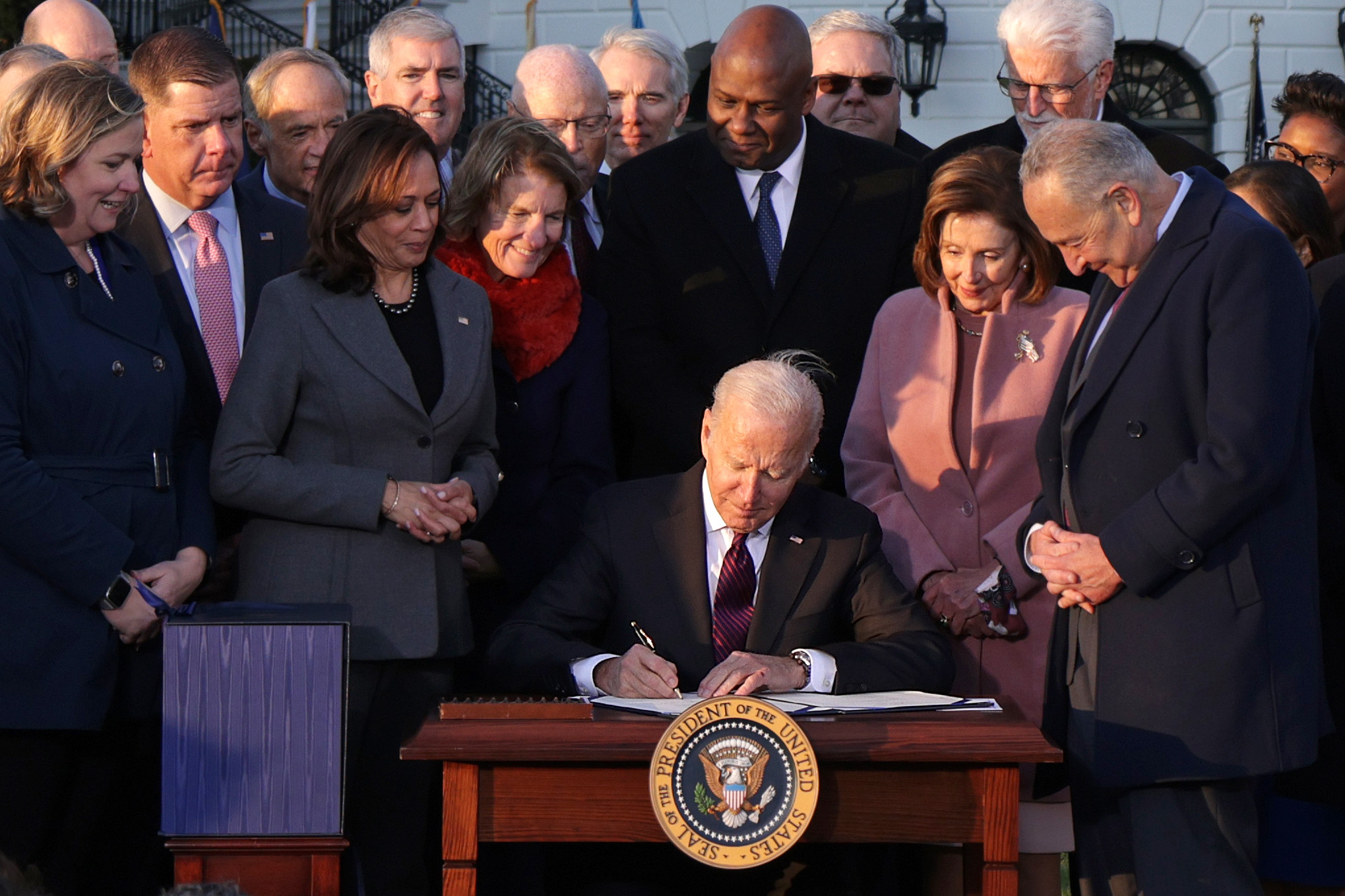 ‘A blue-collar blueprint to rebuild’: Biden signs infrastructure package
